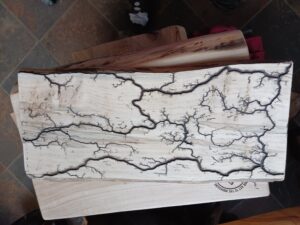 Wood carved slab with branching pattern