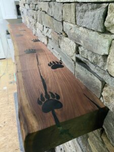 Wood carved mantle with bear tracks